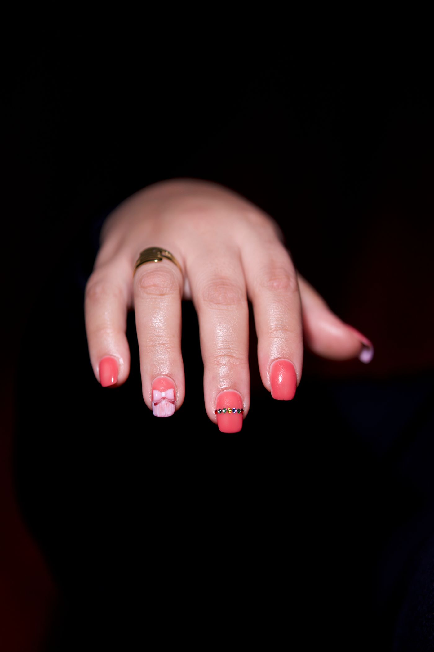 Intricate pink nail art set with gold accents